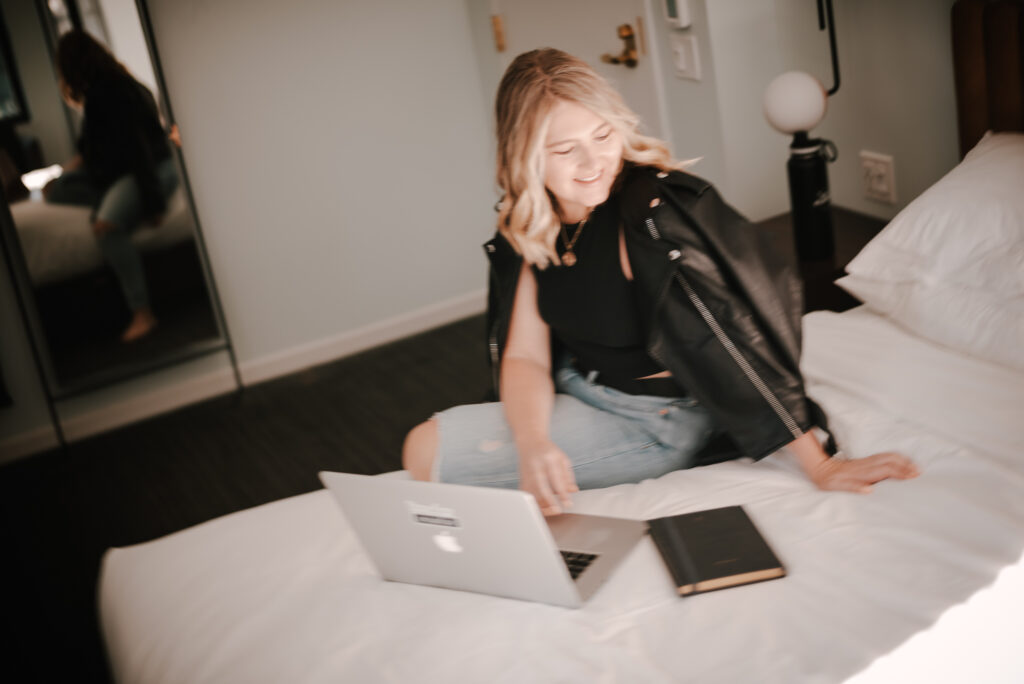 Female entrepreneur on laptop working on their website