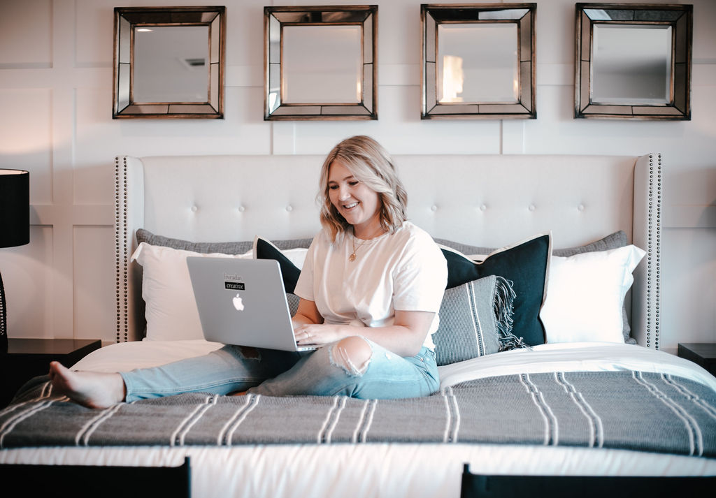 Female creative entrepreneur writing brand story on laptop